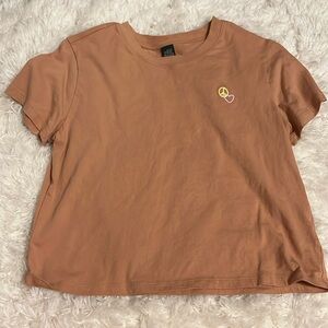 Orange wild fable top with peace sign and heart embroidery